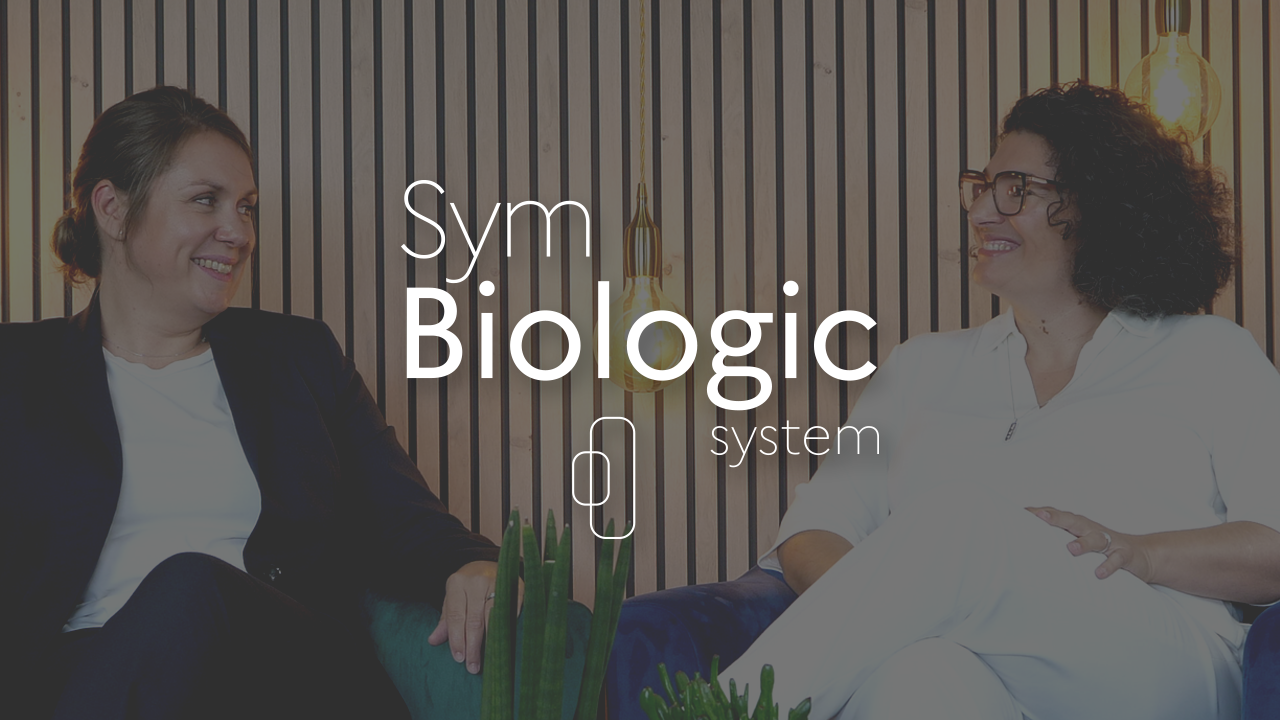 Sym Biologic System logo with Elodie Crocilla and Morgane Allain in the background.