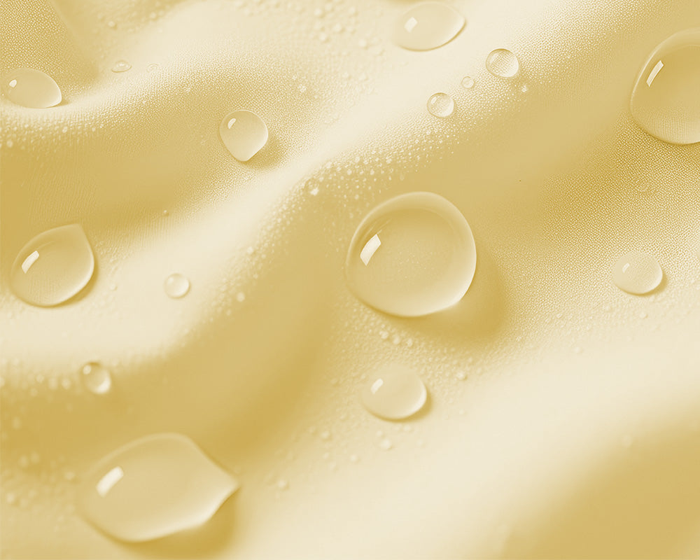 Macro of sparkling cosmetic oil drops, evoking energizing and revitalizing hydration for the body.
